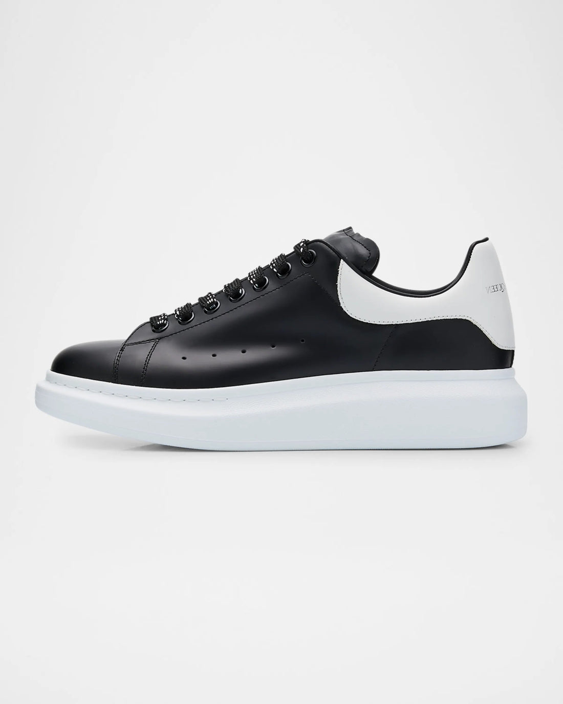 Black and white sneaker on a light gray background